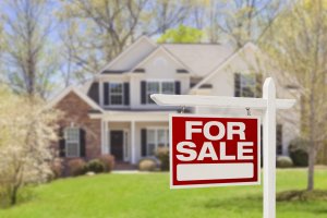 selling your home and house for sale sign in yard of beautiful house