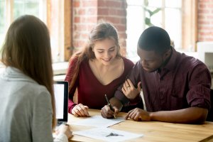 Young couple meeting with agent and refinancing their mortgage