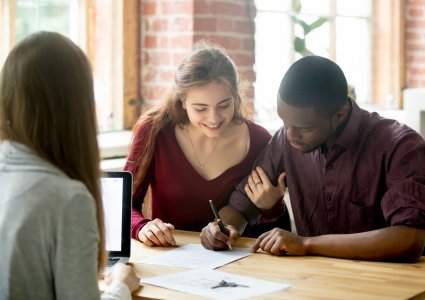 Young couple meeting with agent and refinancing their mortgage