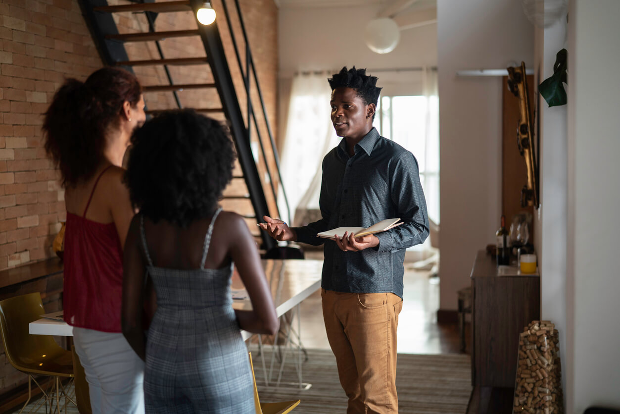 Two women touring homes with a real estate agent