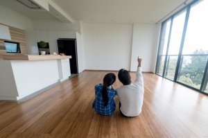 A couple sitting in their new house, owning a home concept