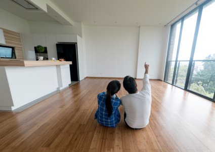 A couple sitting in their new house, owning a home concept