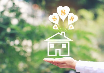 A hand held out flat with the palm up and an illustration of a house with heart-shaped balloons with dollar signs coming out of the chimney