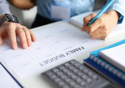 Two people creating a budget for new house | SIGNATURE PROPERTIES GROUP