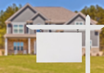 blank real estate sign in front of house | SIGNATURE PROPERTIES GROUP