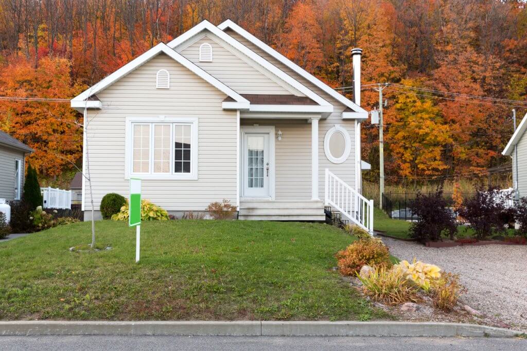 White residential house processed for an autumn home selling