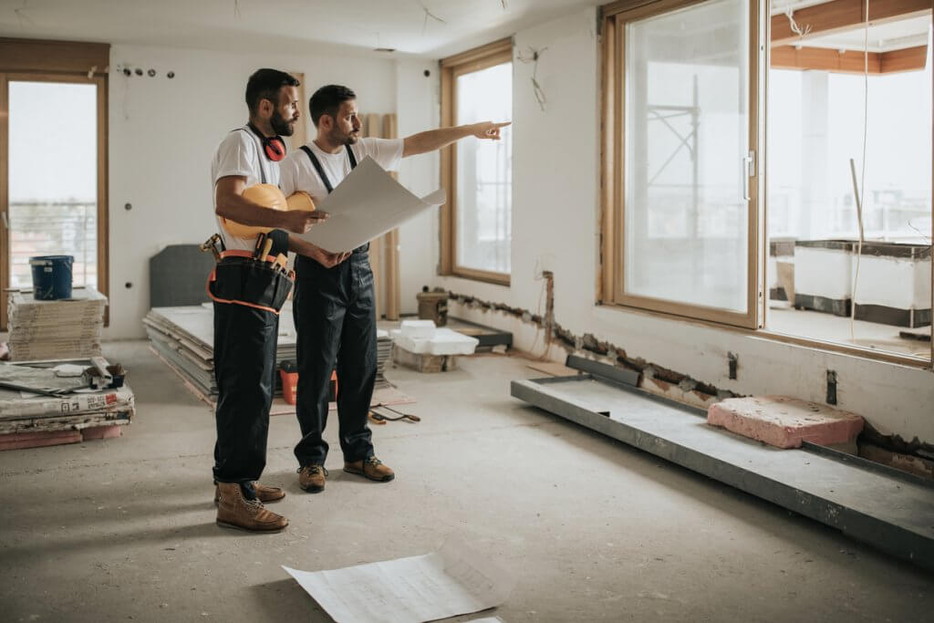 Two male construction workers in the process of home flipping